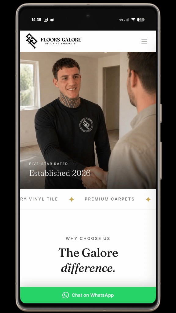 Floors Galore website shown on a mobile phone — full-bleed hero image of Zak meeting a client, with a sticky 'Chat on WhatsApp' bar at the bottom