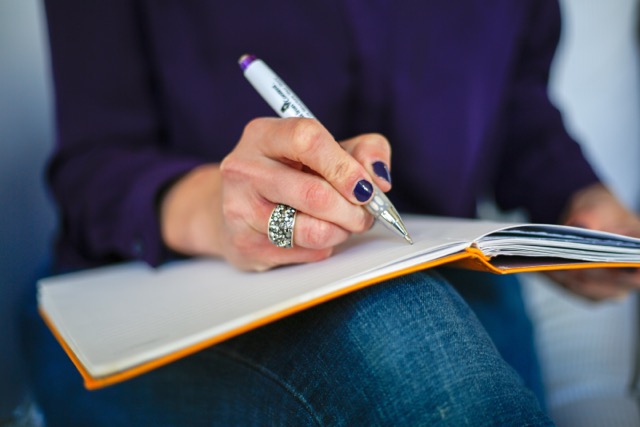 Why Great Writing Isn't Enough for Your Website — And What To Do About It 2 Woman writing on a notebook with a pen Medium